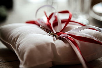 engagement photos, jewellery, jewelry, marriage photos, wedding photos, rings, pillow, red ribbon, white pillow, wedding accessories, romantic setting