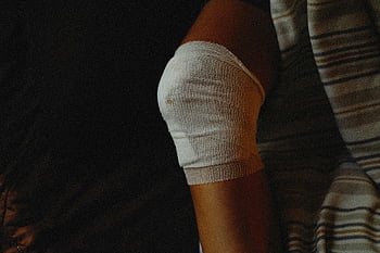 medical gauze, bandage, injured knee, injury care, healing process, detailed view, knee injury, medical treatment, bandaged knee, medical bandage, injury healing