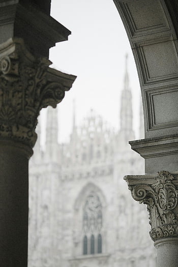 aged Gothic cathedral, columns, intricate Gothic facade, ornate architectural arches, Gothic architecture, cathedral spires, historical building, stone columns, Gothic design, cathedral details, architectural details