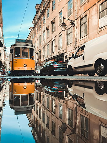 Lisbon, tram, reflection, puddle, city buildings, street, charm, yellow tram, urban scene, Portugal, mirror effect