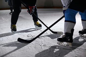 ice hockey, hockey players, ice hockey uniform, ice hockey stick, face-off, lighted ice rink, close-up, intense game, puck battle, sports action, ice rink