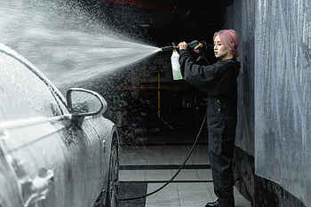 car washing, high-pressure hose, young woman, garage, water splash, foam, cleaning car, garage interior, car care, vehicle maintenance, pressure washing