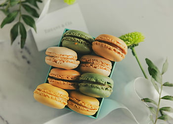 macarons, Tiffany box, pastel colors, elegant assortment, flower decor, close-up shot, macaron box, food photography, gourmet treats, dessert presentation, macaron assortment