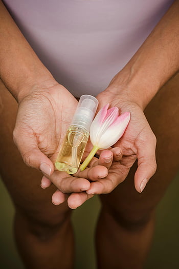 essential oil, tulip, natural skincare, hands holding, close-up, bottle, flower, skincare products, aromatherapy, natural beauty, wellness