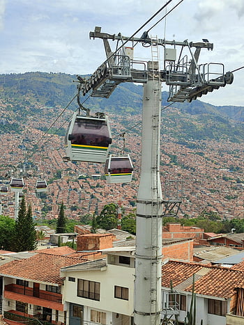 cable car, Medellin, urban landscape, city rooftops, vibrant view, cable cars, Medellin cable car, cityscape, aerial transport, Colombian city, mountain view