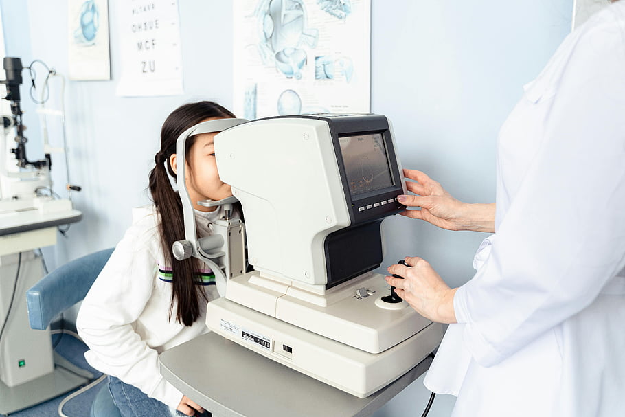 eye exam, modern optometry clinic, professional optometrist, eye check up, optometry equipment, pediatric eye care, eye health, medical examination, vision testing, clinic setting, eye doctor