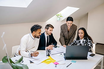 collaborative meeting, group of people, working together, laptop, bright office, colleagues, teamwork, office space, professional setting, business meeting, documents
