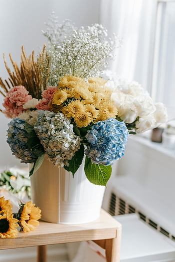 multicolored bouquet, flowers in vase, wooden table, elegant floral arrangement, blue hydrangeas, roses, daisies, white vase, indoor flowers, decorative flowers, home decor
