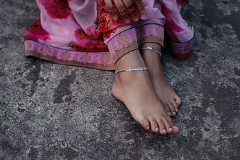 woman's feet, anklet, traditional South Asian attire, close-up, artistic, barefoot, cultural jewelry, ethnic fashion, foot jewelry, silver anklet, floral dress