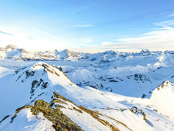 Swiss Alps, snowy peaks, winter beauty, clear blue sky, serene landscape, mountain view, winter scenery, alpine landscape, snow-covered mountains, winter mountains, breathtaking view