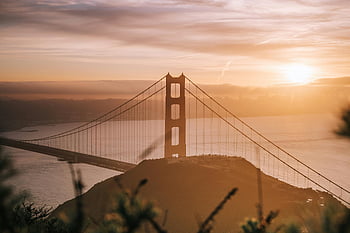 Golden Gate Bridge, San Francisco, California, sunrise view, iconic landmark, warm glow, stunning view, bridge photography, San Francisco photography, sunset photography, landmark photography