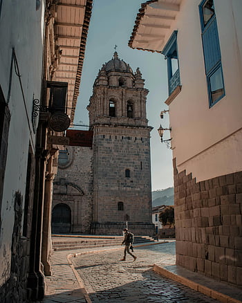 Santo Domingo Convent, Cusco, Peru, historic tower, cobblestone street, colonial architecture, Cusco architecture, Peru landmarks, colonial buildings, Cusco streets, historic sites