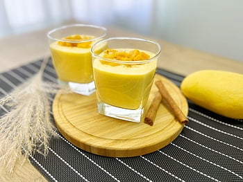 mango lassi, creamy mango lassi, diced mango, cinnamon sticks, round wooden board, glasses of lassi, mango dessert, mango drink, wooden serving board, summer drink, healthy dessert