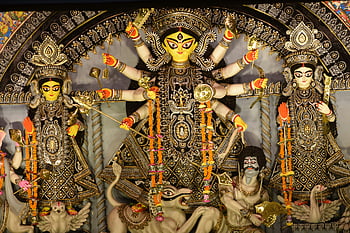 Hindu Goddess, Durga Puja, vibrant idol, intricate decorations, festival in India, Goddess Durga, close-up photo, Durga Puja festival, Indian festival, religious idol, cultural celebration