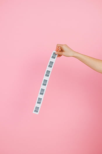 i codici a barre, sfondo rosa, mano che regge, striscia di codice a barre, Immagine semplice, Immagine sorprendente, etichette con codice a barre, design minimalista, foglio di codici a barre, mano contro il rosa
