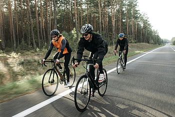 Tři lidé na kole, cyklisty, malebné silnici, svěží les, venkovní dobrodružství, jízdní kola, cyklistická skupina, jízda lesem, silniční cyklistika, trio na kole, cyklistika v přírodě