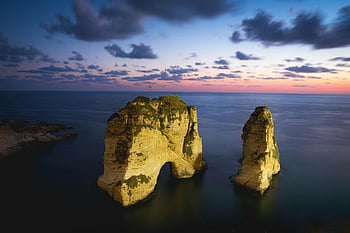 Pigeon Rock, Beirut, sunset, natural beauty, vibrant colors, sea, rock formation, Lebanon, coastal landscape, travel destination, landmark