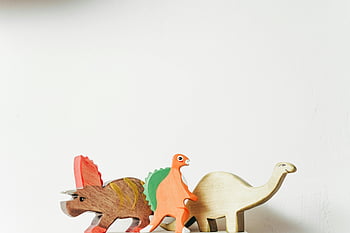 wooden dinosaur, white background, wooden toys, dinosaur toys, playful creativity, wooden figures, toy dinosaurs, creative play, wooden craft, dinosaur collection, white surface