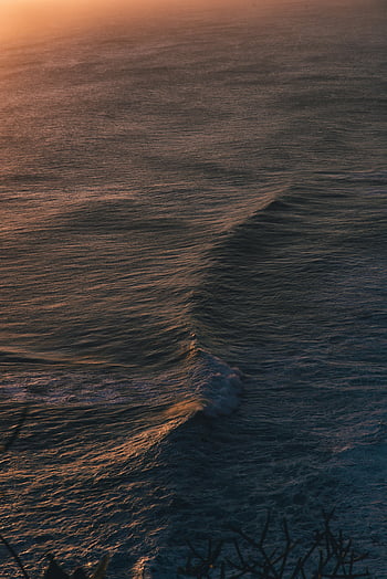 aerial view, ocean waves, sunset, Bali, Indonesia, nature's beauty, captivating, sea, wave patterns, coastal scenery, natural landscape