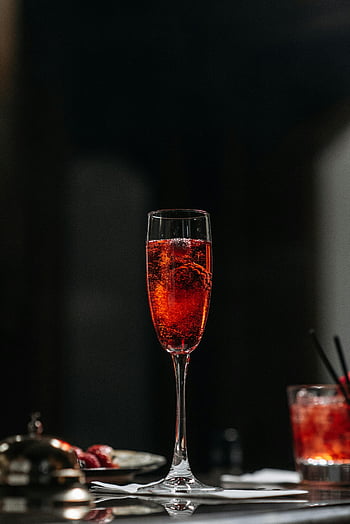 wine glass, bubble liquid, sparkling red cocktail, chic flute, elegant drink, dark background, celebration beverage, festive drink, red cocktail, cocktail glass, sparkling drink