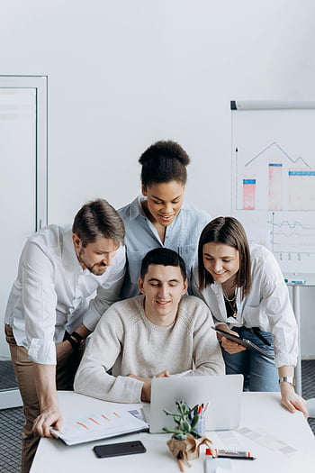 businesspeople, team collaboration, diverse team, modern office, laptop, colleagues, working together, professional setting, office environment, group work, teamwork