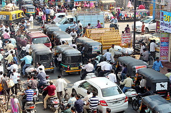 urban street, crowded street, city traffic, cars, bikes, auto rickshaws, bustling city, people walking, street scene, busy street, traffic jam