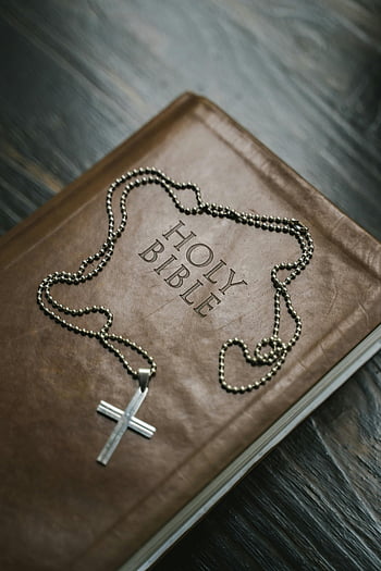 Sacra Bibbia, collana croce, croce d'argento, fede cristiana, simbolo religioso, bibbia marrone, Immagine ravvicinata, gioielli di fede, accessorio spirituale, libro religioso, Croce ciondolo