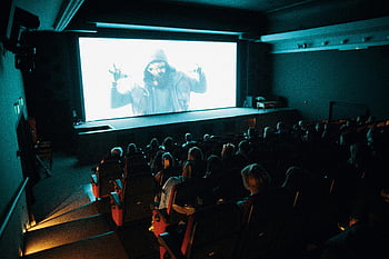 movie theater, cinema, large screen, audience, dark setting, crowded theater, watching movie, cinema audience, theater seats, film screening, movie night