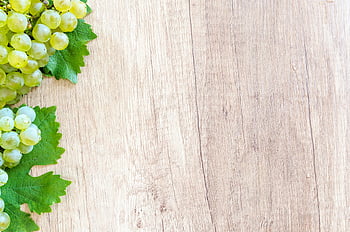 green grapes, brown wooden panel, fresh grapes, wooden table, grape leaves, cluster of grapes, green grape cluster, wooden background, fresh green grapes, grape bunch, grape leaf