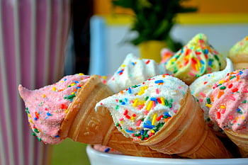 ice cream cones, colorful sprinkles, summer treats, vibrant ice cream, white sprinkled icing, brown cone, ice cream cone, dessert, sweet treats, summer dessert, colorful ice cream