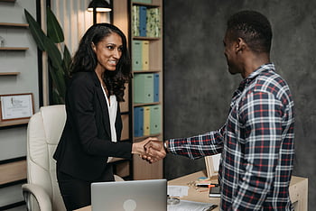 female lawyer, client handshake, modern office, successful agreement, professionals shaking hands, business meeting, office setting, professional handshake, business people, office environment, agreement symbol