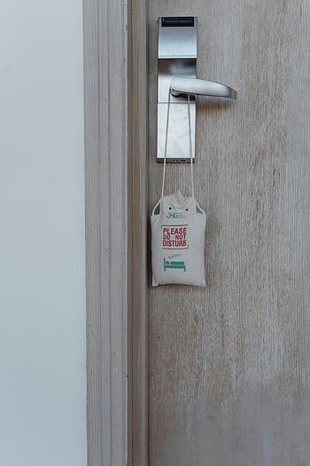 do not disturb sign, hotel room door, door handle, close-up, do not disturb, sign on door, hotel door, door sign, do not disturb sign hotel, door handle sign, do not disturb hotel
