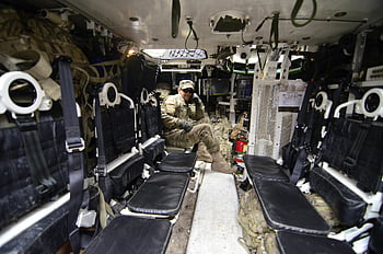 soldier, armored vehicle, military equipment, black leather seat, military seating, soldier suit, interior view, combat gear, tactical vehicle, military personnel, vehicle interior