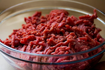 ground beef, glass bowl, fresh meat, culinary themes, food photography, high-quality image, meat preparation, beef in bowl, raw meat, cooking ingredients, food presentation