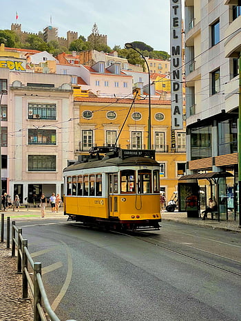 yellow tram, white tram, Lisbon tram, vibrant streets, Lisbon Portugal, iconic tram, city streets, urban transport, tramway, tram route, tram 28