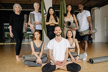yoga studio, group of people, diverse group, practicing yoga, positive energy, smiling people, studio setting, yoga mats, indoor yoga, fitness group, wellness class