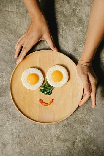 fried eggs, smiley face, breakfast arrangement, wooden plate, playful breakfast, vegetables, egg art, food art, creative breakfast, egg smiley, egg face