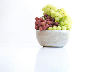 grapes, round gray bowl, fresh grapes, red grapes, green grapes, ceramic bowl, white surface, minimalistic shot, fruit bowl, healthy food, still life