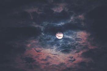 full moon, night sky, dark clouds, moody atmosphere, celestial scene, moonlit night, dramatic clouds, night clouds, full moon photography, moon behind clouds, atmospheric night sky