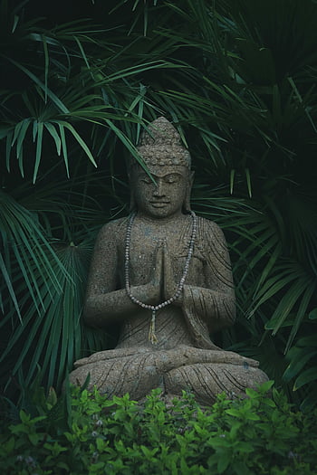 Buddha sculpture, garden, serene, stone Buddha statue, meditation, vibrant green foliage, peaceful zen atmosphere, outdoor, nature, spiritual, art