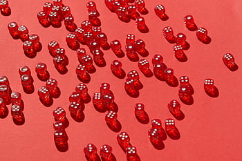 red dice, scattered dice, red background, vivid red, multiple dice, striking visual, red surface, dice composition, red gaming, dice art, red objects