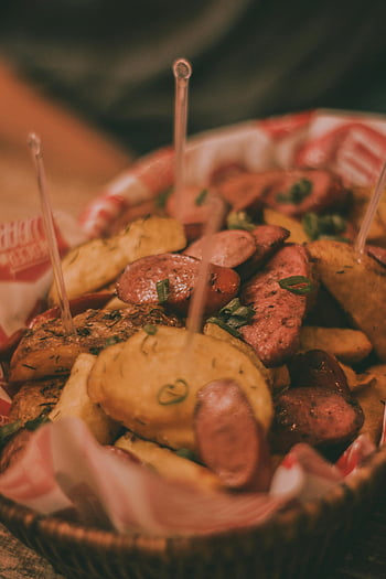 Peruvian cuisine, sausages, potatoes, close-up food, rich flavors, food enthusiasts, Peruvian dish, grilled sausages, roasted potatoes, food photography, culinary delight