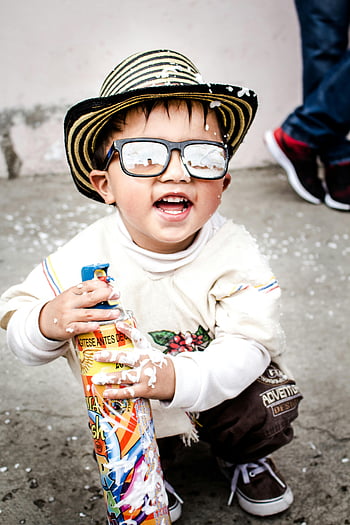 child photography, kid wearing sunglasses, happy child, foam spray, Colombia, child playing, sunglasses and hat, outdoor play, playful child, colorful foam, adventure design