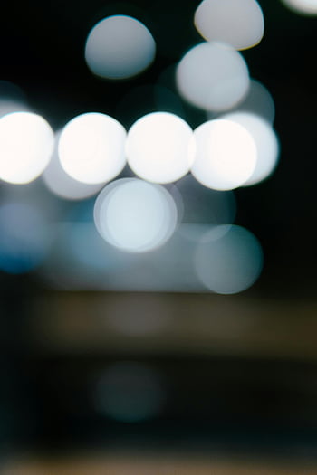 white bokeh lights, blue bokeh lights, defocused lights, abstract illuminated pattern, dark background, bokeh circles, white and blue bokeh, night photography, light blur, bokeh effect, abstract lights