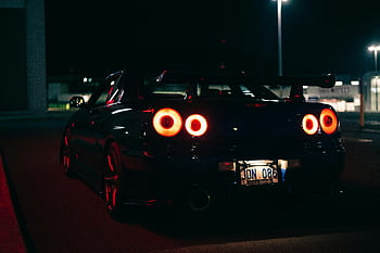 Nissan Skyline R34, rear view, nighttime parking, street lights, car park, night time, illuminated car, parking lot, rear lights, sports car, night scene
