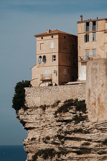 fortress on a hill, Bonifacio, Corsica, historic fortress, cliffs, sea view, summer sun, sunlight, stone wall, Mediterranean architecture, coastal fortress