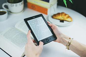 Kindle, e-book reader, woman reading, croissant, table, book, coffee cup, digital reading, e-reader, breakfast, cozy reading