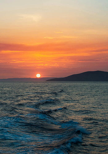 sunset at sea, Paros sunset, Aegean Sea, serene beauty, travel inspiration, relaxation, ocean waves, sunset photography, coastal landscape, evening sky, island view