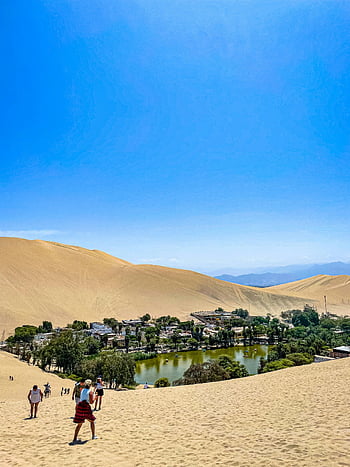 Huacachina, Ica, Peru, desert oasis, stunning landscapes, top travel destination, breathtaking views, sand dunes, green oasis, village in desert, Huacachina lake