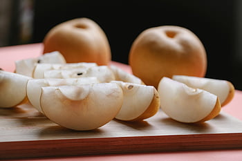 Asian pear, sliced pears, wooden board, fresh fruit, ripe texture, juicy pears, fruit slices, healthy snack, food photography, natural ingredients, Asian cuisine